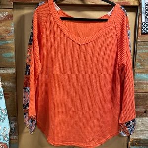 Tangerine colored top V-neck paisley print on sleeves, long sleeve
